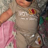 baby, child, sunglasses, wearing_clothes, winnie_the_pooh, beige_outfit, blanket, pillow, floral_pattern, pink_blanket, indoor, cute, portrait, laying_down, sleepy, infant, person, cool, flash_photography, relaxing