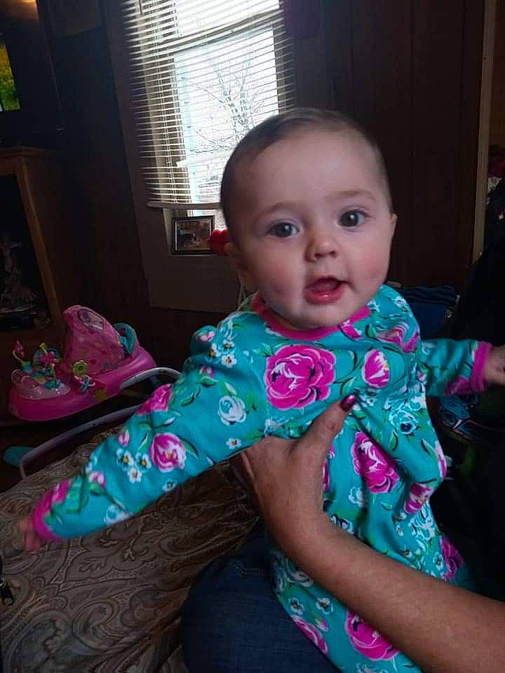 Pasiley is registered to the contest to win money with this photo: baby, baby_toddler_clothing, cheek, child, event, eye, face, fun, happy, human_body, iris, magenta, person, pink, purple, sitting, skin, sleeve, toddler, window