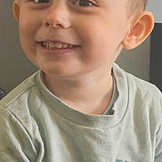 Parker is registered to the contest to win money with this photo: child, smiling, portrait, indoor, toddler, face, clothing, cartoon, shirt, happy, cute, young, person, expression, light_green, short_hair, casual, sitting, bluey, illustration