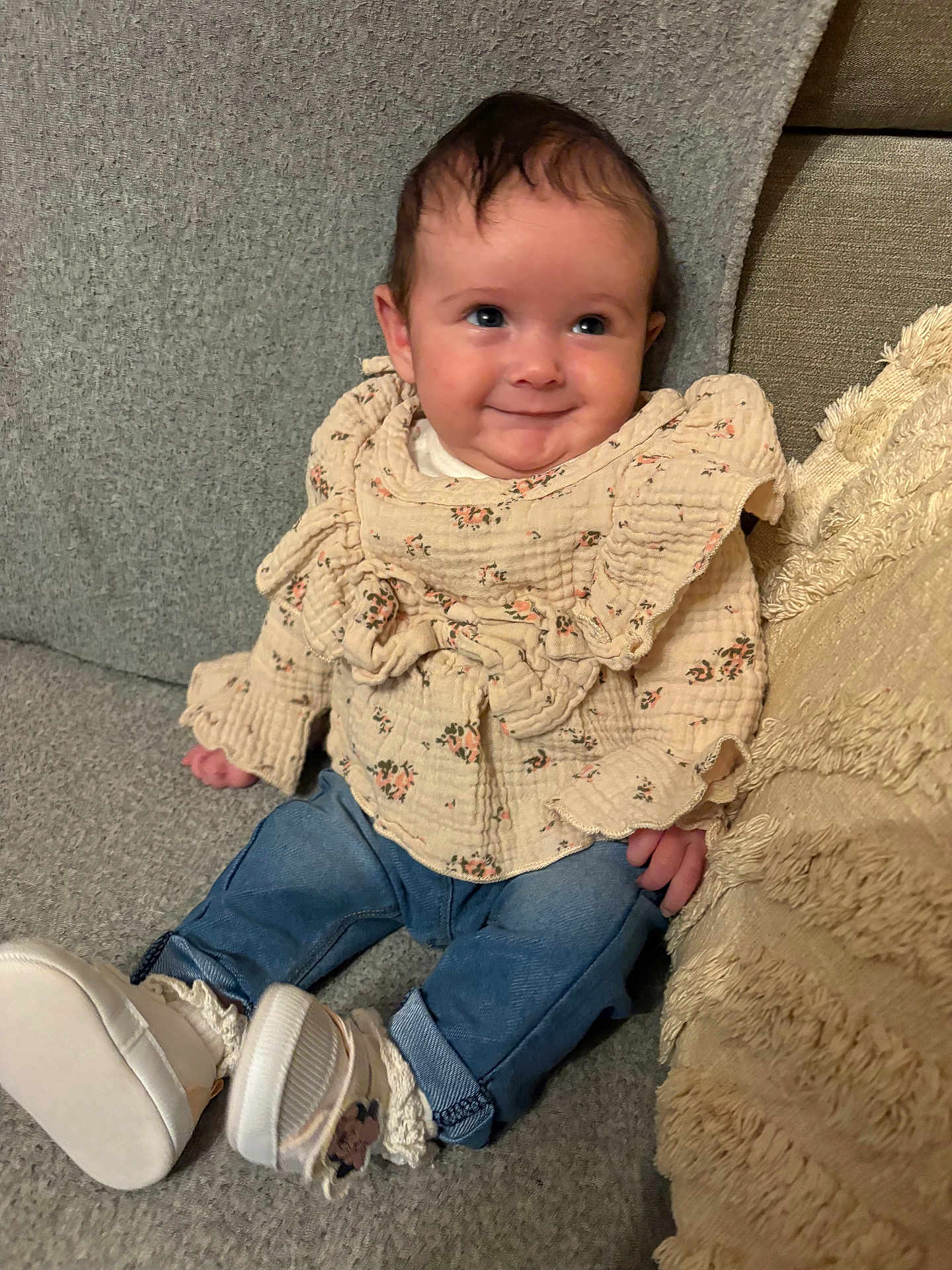 Lina a rejoint le concours — aidez-le/la à gagner de superbes lots ! baby, infant, smiling, face, couch, blanket, pillow, floral_blouse, jeans, socks, white_shoes, eyes, hair, portrait, indoors, cozy, cute, sitting, hands, fabric_texture