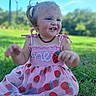 child, toddler, smiling, pink_dress, strawberry_pattern, grass, outdoor, sunny, blue_sky, hair_clip, happy, nature, baby, summer, cute, portrait, sitting, daylight, greenery, face