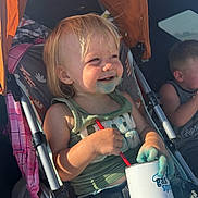 Rhiggs joined the competition — help win amazing prizes! toddler, child, stroller, smiling, blue_stain, sunlight, cup, straw, casual_clothing, jeans, tank_top, outdoor, happy, messy, sitting, person, baby, hair, face, playful
