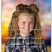 Blakely is registered to the contest to win money with this photo: child, girl, portrait, smile, curly_hair, plaid_shirt, hair_buns, blue_eyes, posing, studio_background, colorful_background, happy, young, fashion, casual_wear, child_portrait, cute, blonde, outdoor_style, photography