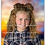 child, girl, portrait, smile, curly_hair, plaid_shirt, hair_buns, blue_eyes, posing, studio_background, colorful_background, happy, young, fashion, casual_wear, child_portrait, cute, blonde, outdoor_style, photography