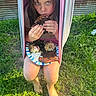 Blakely joined the competition — help win amazing prizes! child, barefoot, hammock, food, plate, sandwich, grass, outdoor, summer, casual, eating, person, greenery, rustic, metal_siding, nature, snack, relaxed, daylight, portrait