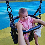 Ashley joined the competition — help win amazing prizes! baby, child, swing, playground, hands, pink_dress, smiling, outdoor, fun, play, seat, chain, person, happy, infant, feet, daylight, park, support, cute