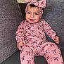 Ashley is registered to the contest to win money with this photo: baby, child, smiling, pink_outfit, headband, pi_symbol, couch, indoor, happy, portrait, sitting, clothing, person, face, cute, home, infant, cozy, headwear, comfortable