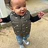 Mi'Zeir joined the competition — help win amazing prizes! casual_clothing, child, concrete, curious, curly_hair, cute, daylight, green_vest, happy, jeans, motion, outdoor, person, portrait, small_person, smiling, sneakers, standing, toddler, young_child