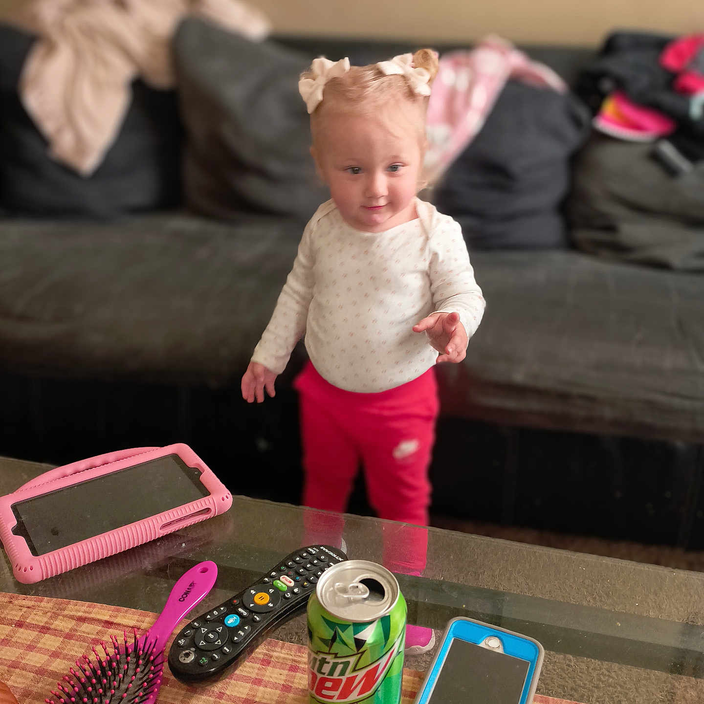 Paislee is registered to the contest to win money with this photo: architecture, baby, building, can, couch, cushion, electronics, face, furniture, head, indoors, livingroom, mobilephone, person, phone, photography, portrait, remotecontrol, room, tin