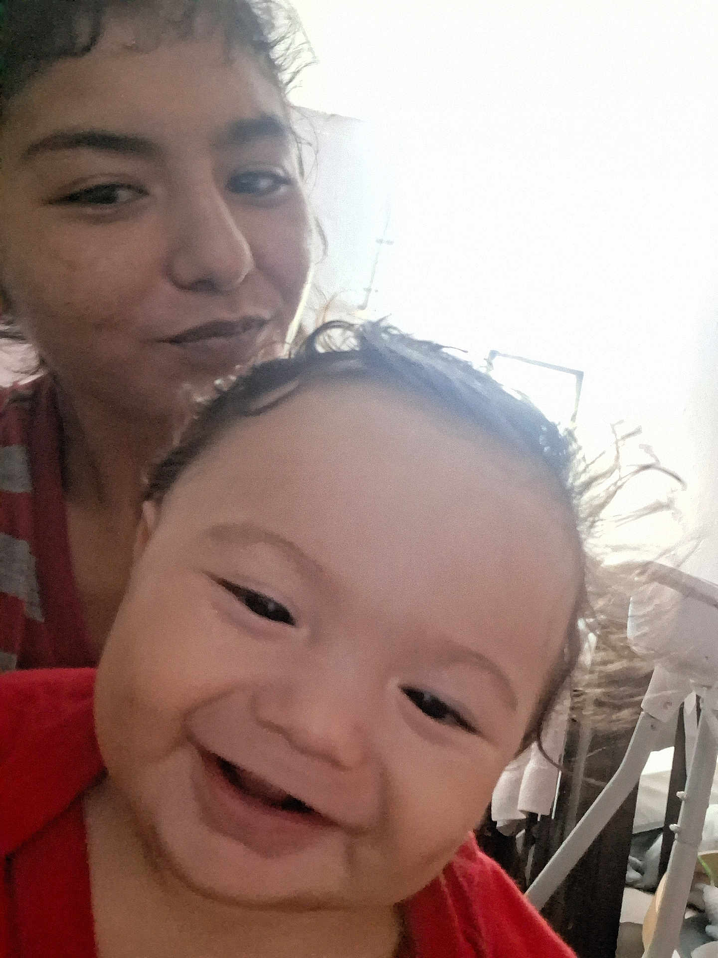 Benito is registered to the contest to win money with this photo: baby, child, smiling, woman, face, portrait, indoors, happy, person, closeup, hair, skin, expression, head, young, candid, casual, light, background, family