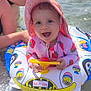 Rose participe au concours pour gagner de l'argent avec cette photo : baby, child, water, inflatable_ring, swimsuit, sun_hat, smiling, summer, beach, adult, water_sports, floating, toy, outdoor, sunlight, vacation, happy, person, playful, holiday