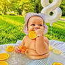 Nicolas is registered to the contest to win money with this photo: baby, infant, child, outdoor, pool, water, orange, citrus, fruit, hat, sunlight, garden, grass, balloon, number_eight, toy_duck, swimming, smiling, portrait, playful