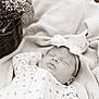baby, sleeping, onesie, headband, bow, blanket, basket, flowers, floral, peaceful, infant, closeup, texture, soft, portrait, monochrome, outdoor, cozy, cute, newborn