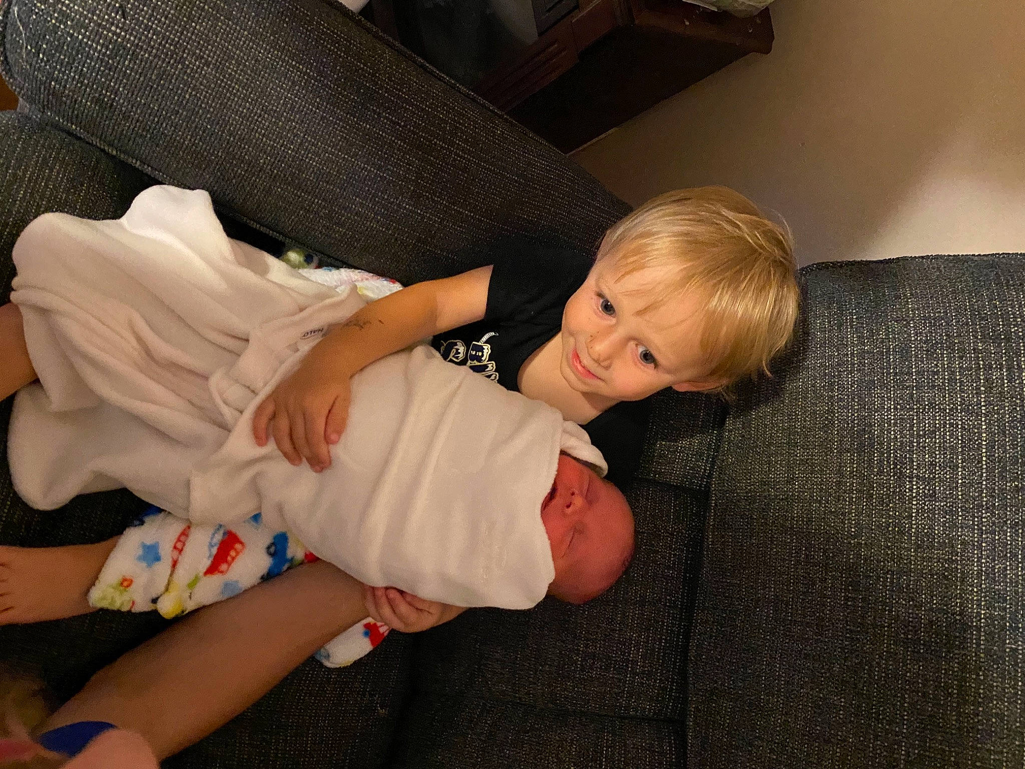 Lincoln joined the competition — help win amazing prizes! abdomen, baby, baby_toddler_clothing, barefoot, comfort, couch, elbow, flooring, foot, fun, human_leg, joy, knee, lap, person, room, sitting, smile, thigh, toddler