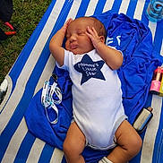 Kaiden joined the competition — help win amazing prizes! baby, infant, onesie, sleeping, blue, white, striped, lounge_chair, grass, clothing, face, person, cute, relaxing, outdoor, soft, sock, peaceful, hand, lying_down