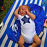 baby, infant, onesie, sleeping, blue, white, striped, lounge_chair, grass, clothing, face, person, cute, relaxing, outdoor, soft, sock, peaceful, hand, lying_down