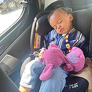 Gabriel participe au concours pour gagner de l'argent avec cette photo : blue_jeans, car_interior, car_seat, child, clothing, cute, indoor, jacket, peaceful, plush_toy, resting, seatbelt, sleeping, stuffed_animal, sunlight, toddler, toy, vehicle, window, young_child