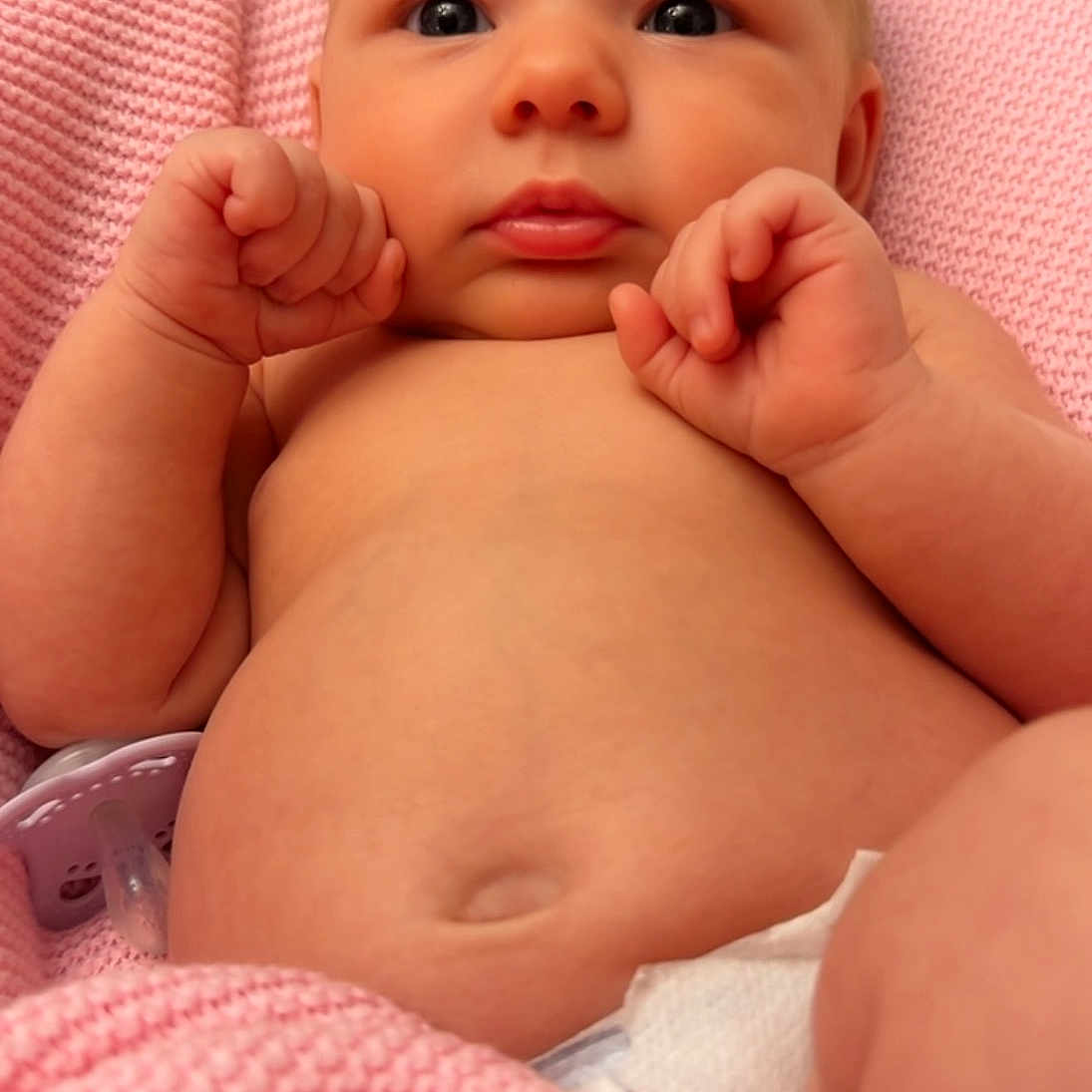 Lamaia joined the competition — help win amazing prizes! baby, blanket, child, closeup, cute, diaper, expression, face, fingers, hands, indoors, infant, lying_down, newborn, pacifier, pink, portrait, resting, skin, soft_texture
