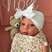 Noel joined the competition — help win amazing prizes! newborn, baby, infant, wrapped, blanket, floral_pattern, headwrap, bow, crocheted_toy, teddy_bear, pink_background, knitted, cozy, cute, portrait, hand, nail_polish, face, eyes, indoors
