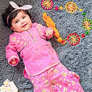 Ana joined the competition — help win amazing prizes! baby, pink_outfit, headband, bunny_ears, smiling, lying_down, gray_rug, decorative_circles, fabric_flowers, cute, child, portrait, indoors, floral_pattern, colorful, soft_texture, happy, person, fashion, playful