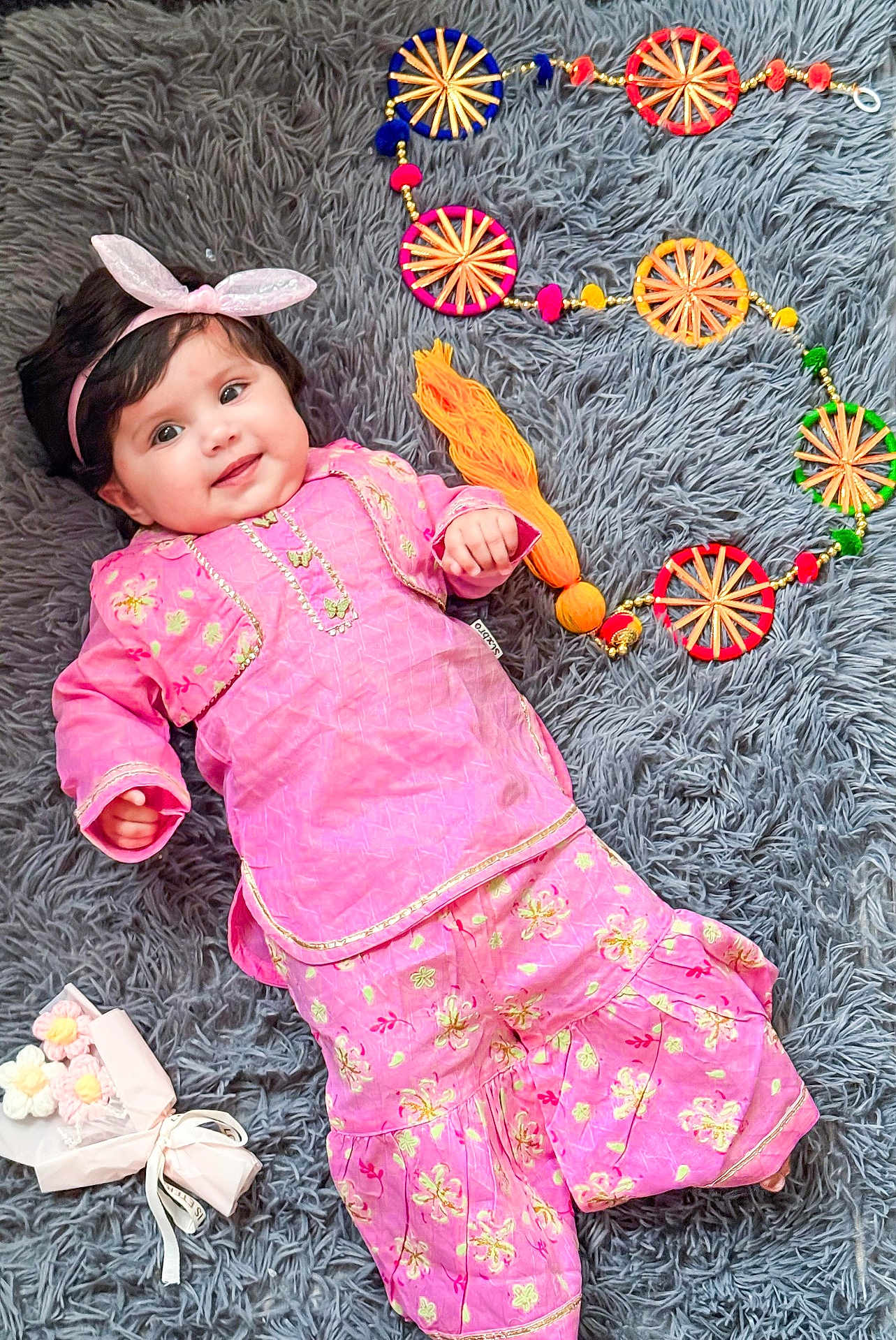 Ana joined the competition — help win amazing prizes! baby, pink_outfit, headband, bunny_ears, smiling, lying_down, gray_rug, decorative_circles, fabric_flowers, cute, child, portrait, indoors, floral_pattern, colorful, soft_texture, happy, person, fashion, playful