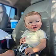 Carbon is registered to the contest to win money with this photo: baby, blue_eyes, car_interior, car_seat, casual, child, clothing, cute, hair, hand, happy, indoor, infant, person, portrait, seat, shorts, smiling, sunlight, toddler
