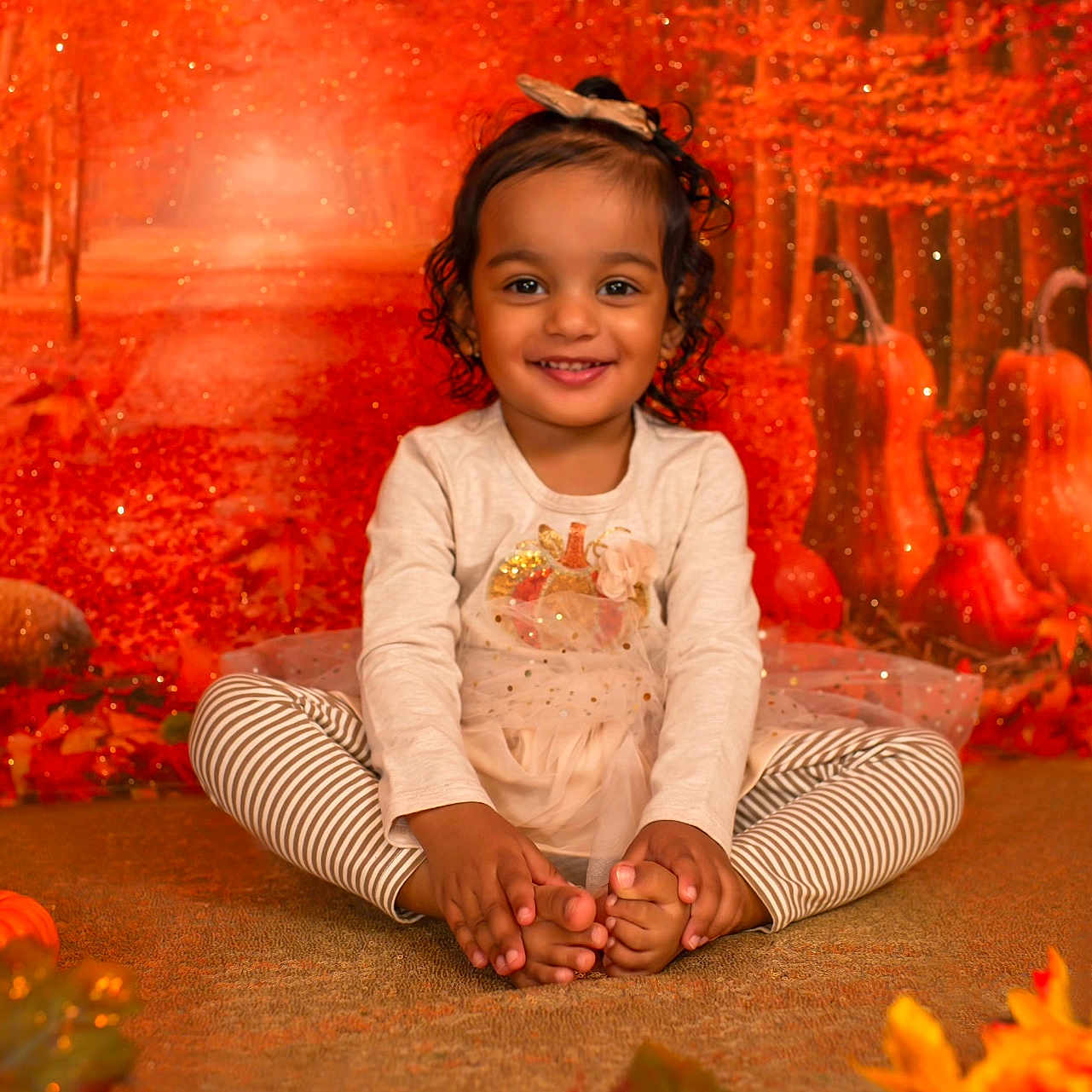 Yasmin is registered to the contest to win money with this photo: bodypart, child, clothing, face, female, finger, flower, girl, hand, happy, head, leaf, pants, person, petal, photography, plant, portrait, sitting, smile