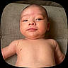 baby, infant, bare_chest, face, skin, expression, lying_down, soft_texture, curious, young_child, head, chubby_cheeks, indoors, portrait, close_up, newborn, person, human, baby_boy, calm
