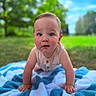 Larry is registered to the contest to win money with this photo: baby, child, infant, crawling, outdoor, blanket, blue_blanket, grass, trees, sky, portrait, close_up, wide_eyes, smiling, sitting, hands, arms, pink_clothing, baby_clothes, text_overlay