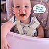 Larry joined the competition — help win amazing prizes! baby, infant, child, smiling, happy, portrait, high_chair, pink, music_notes, speech_bubble, text_overlay, seated, bib, straps, indoor, close_up, face, hands, adorable, parent_love