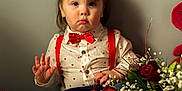 Bentley joined the competition — help win amazing prizes! accessories, baby, bodypart, clothing, face, finger, flower, flowerarrangement, flowerbouquet, formalwear, hand, head, pants, person, petal, photography, plant, portrait, rose, tie