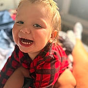 Bentley is registered to the contest to win money with this photo: baby, candid, cheerful, child, closeup, cute, expression, face, hair, happy, indoor, mohawk, person, plaid, portrait, red_shirt, skin, smiling, toddler, warm_light