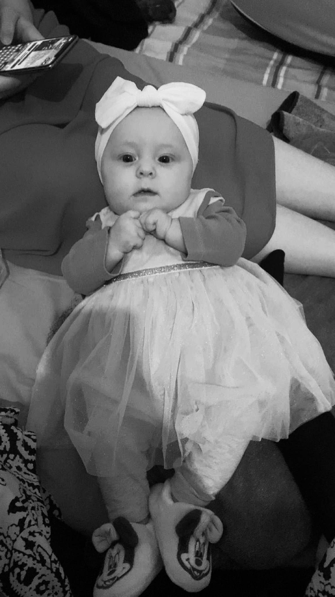 Maddy participe au concours pour gagner de l'argent avec cette photo : baby, baby_products, baby_toddler_clothing, black, black_and_white, comfort, dress, event, fashion_accessory, flash_photography, happy, headpiece, monochrome, monochrome_photography, person, photograph, sitting, snapshot, style, toddler