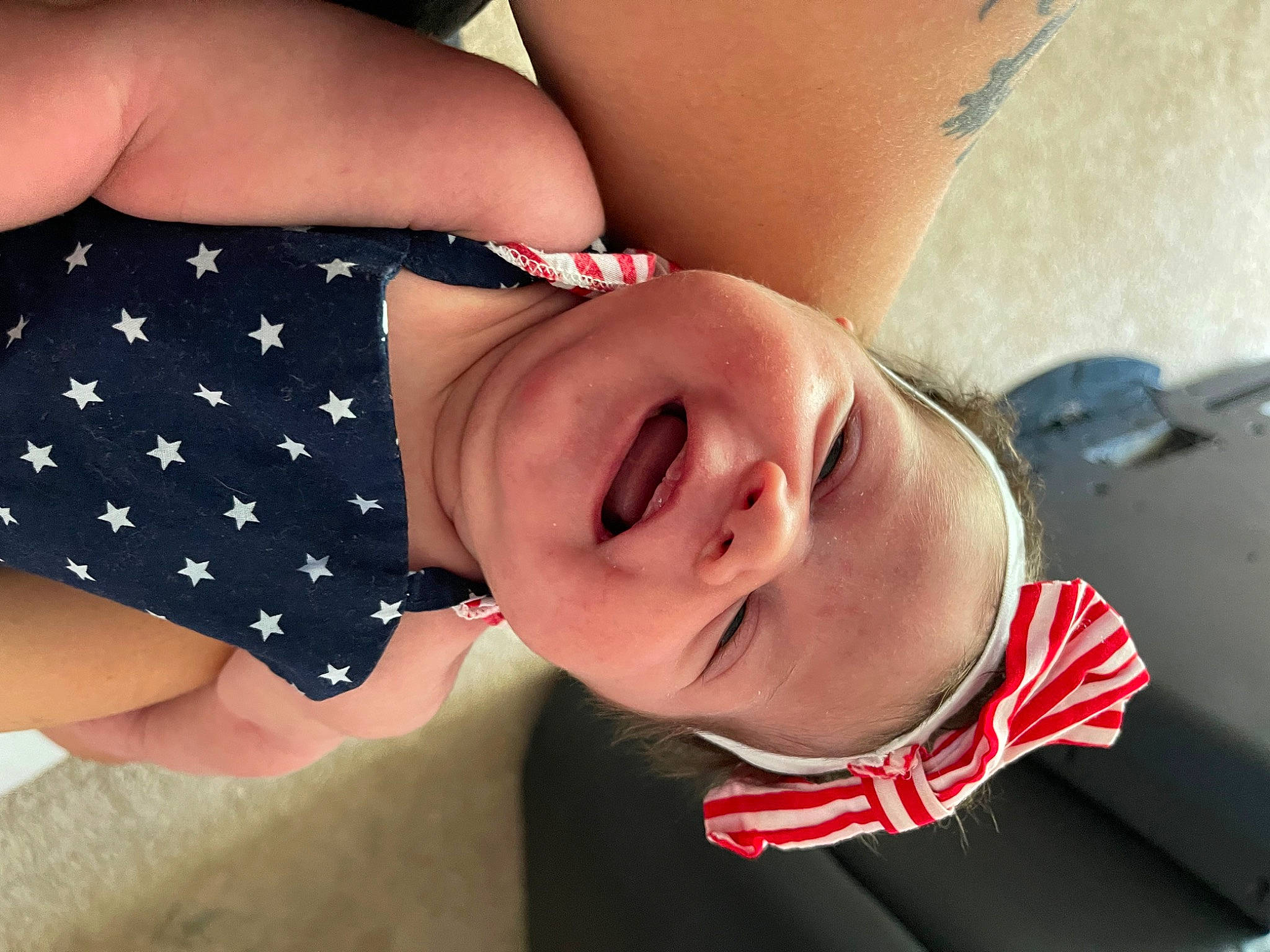 Lilith is registered to the contest to win money with this photo: arm, baby_toddler_clothing, dress, elbow, eye, face, facial_expression, finger, gesture, glasses, hand, happy, head, headgear, human_body, lip, mouth, neck, person, skin