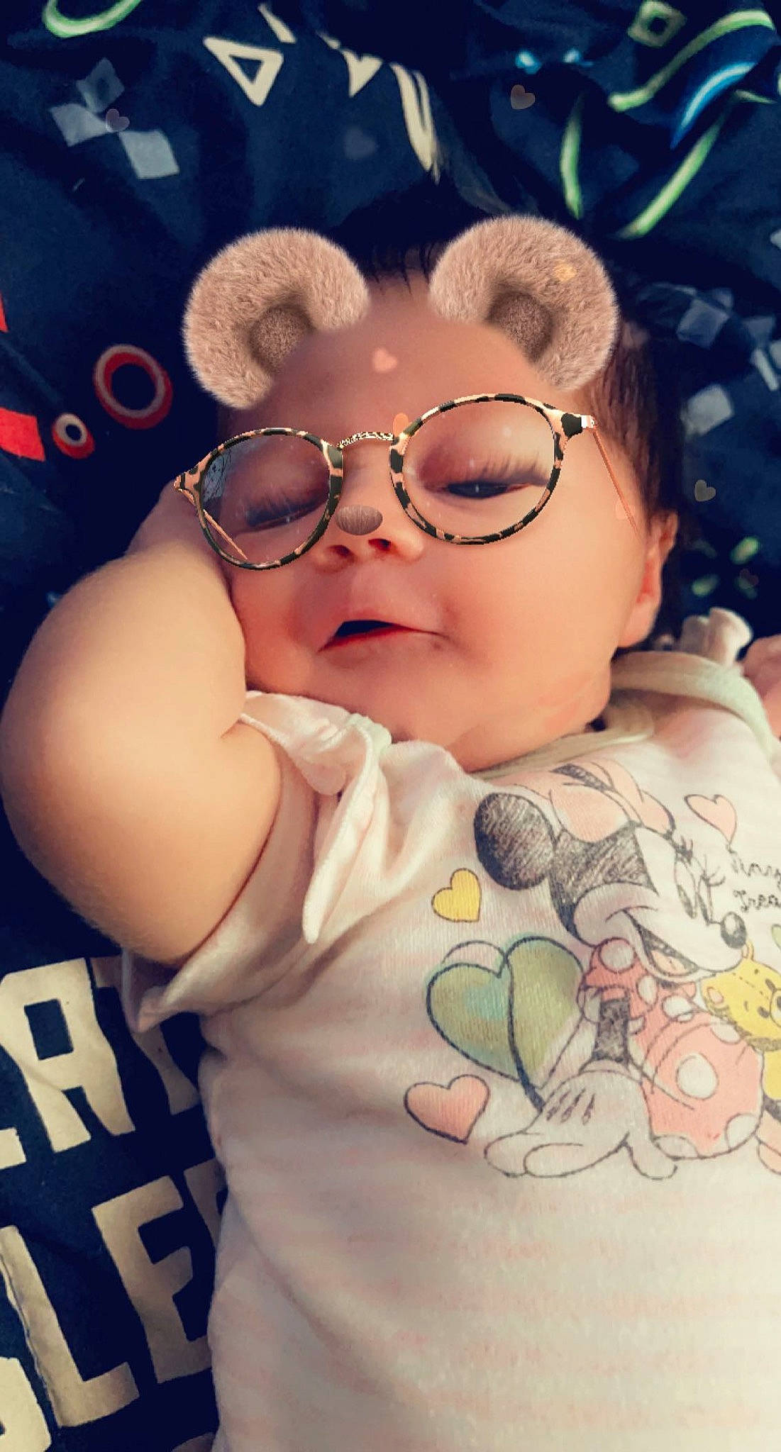 Lilith is registered to the contest to win money with this photo: arm, baby, cap, chest, child, chin, cool, eyewear, fashion_accessory, finger, flash_photography, fun, gesture, happy, pattern, peach, person, skin, thumb, toddler