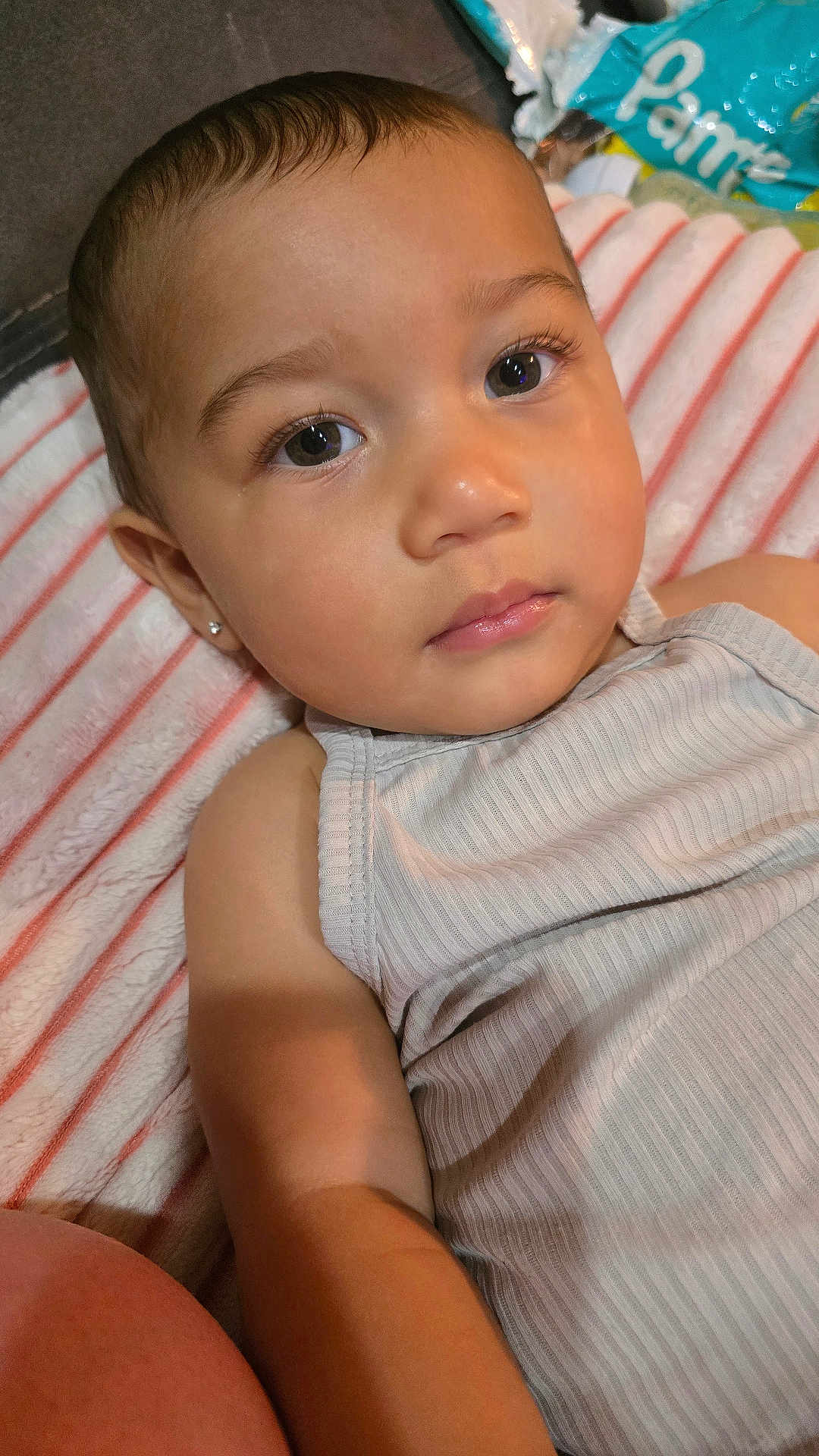 Koaa joined the competition — help win amazing prizes! toddler, child, face, closeup, blanket, striped, curious, portrait, skin, eyelashes, clothing, earring, indoors, baby, person, casual, relaxed, young_child, head, expression