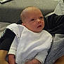 Ambre participe au concours pour gagner de l'argent avec cette photo : baby, infant, bib, clothing, person, arm, hand, couch, furniture, indoor, blanket, fabric, striped_shirt, holding, newborn, face, skin, eyes, head, comfort