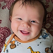 John August joined the competition — help win amazing prizes! baby, smile, infant, face, happy, onesie, animal_print, giraffe, lion, zebra, child, portrait, cute, toddler, closeup, indoors, blanket, pattern, hair, skin