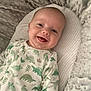 Kylo joined the competition — help win amazing prizes! baby, smiling, infant, onesie, dinosaur_pattern, blanket, cozy, cute, child, portrait, lying_down, happy, soft_texture, sleeping_bed, indoors, young_child, head, face, skin, person