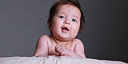 Deyna joined the competition — help win amazing prizes! baby, infant, child, face, portrait, skin, hair, expression, curious, blanket, soft_texture, indoor, cute, young, chubby, hands, looking, head, eyes, neutral_background