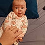 Hope joined the competition — help win amazing prizes! baby, infant, onesie, hand, bed, pillow, adult_hand, ring, pattern, animal_print, face, expression, sleepwear, cute, child, person, indoors, skin, holding, pacifier