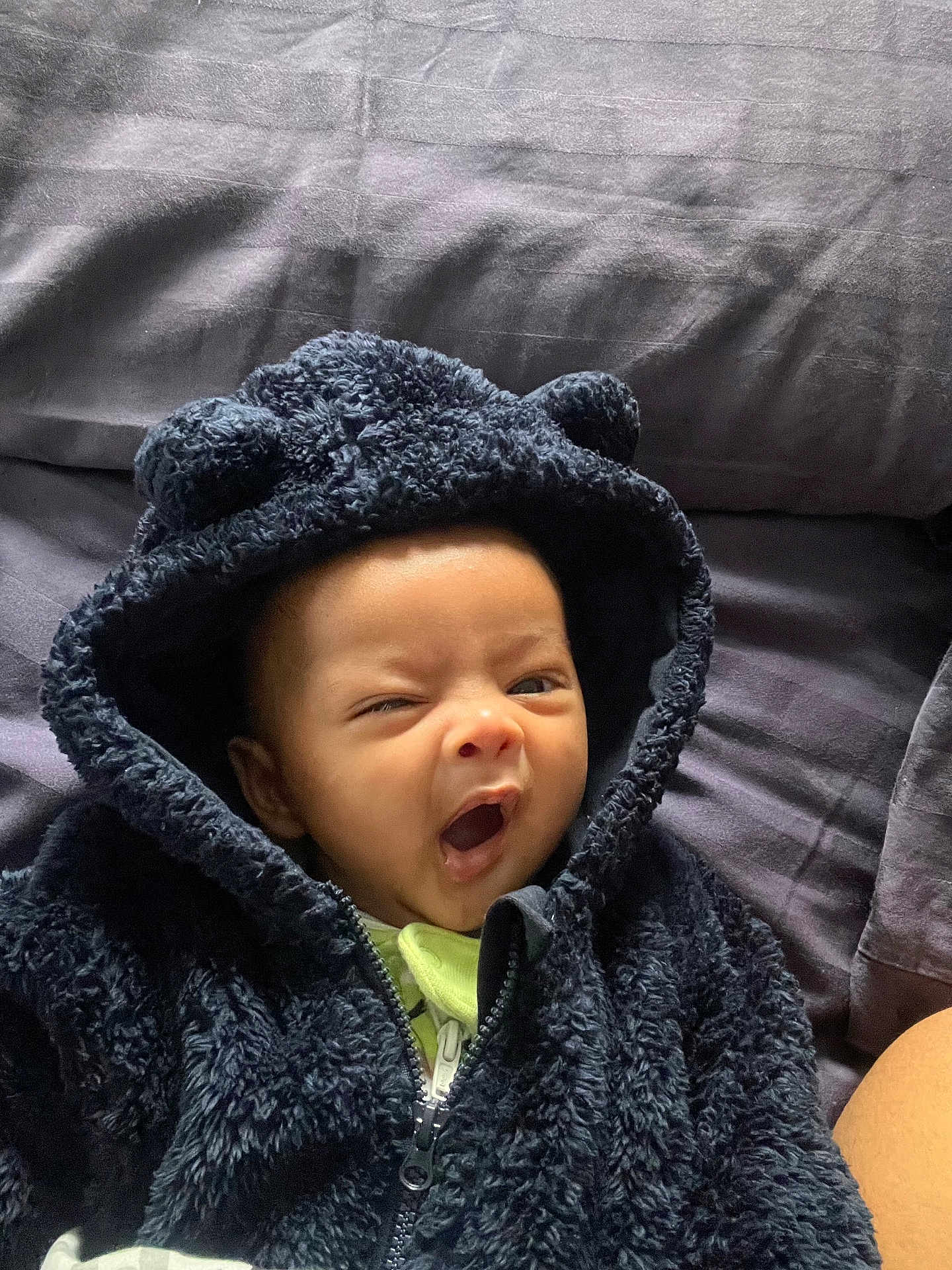 Adam joined the competition — help win amazing prizes! baby, hoodie, black_clothing, yawning, infant, cute, face, child, soft_texture, ears, bed, blanket, sleepy, toddler, portrait, expression, warm_clothing, cozy, person, indoor