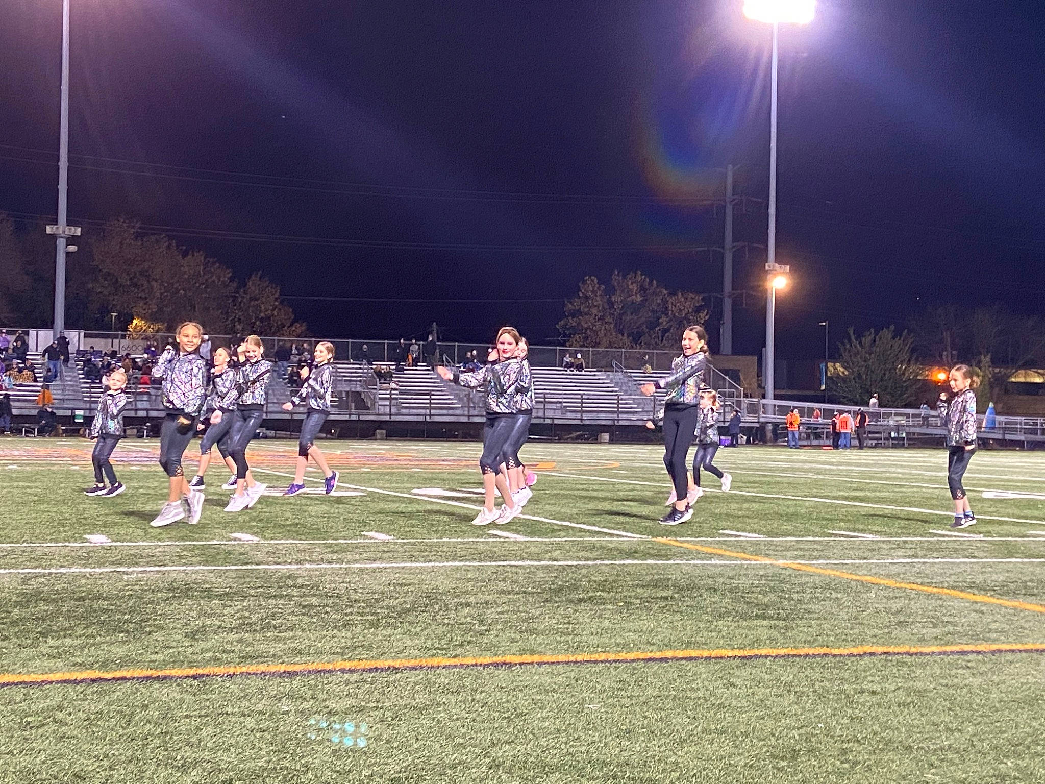 Kennedy is registered to the contest to win money with this photo: atmosphere, ball_game, blurred, championship, competition, competition_event, darkness, fun, grass, jersey, joy, midnight, night, person, player, recreation, sky, sport_venue, sports, street_light