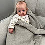 Elodie joined the competition — help win amazing prizes! baby, blanket, chair, cushion, infant, knit, onesie, person, plush, portrait, relaxing, seated, smiling, soft, toddler, cute, indoor, child, fabric, home
