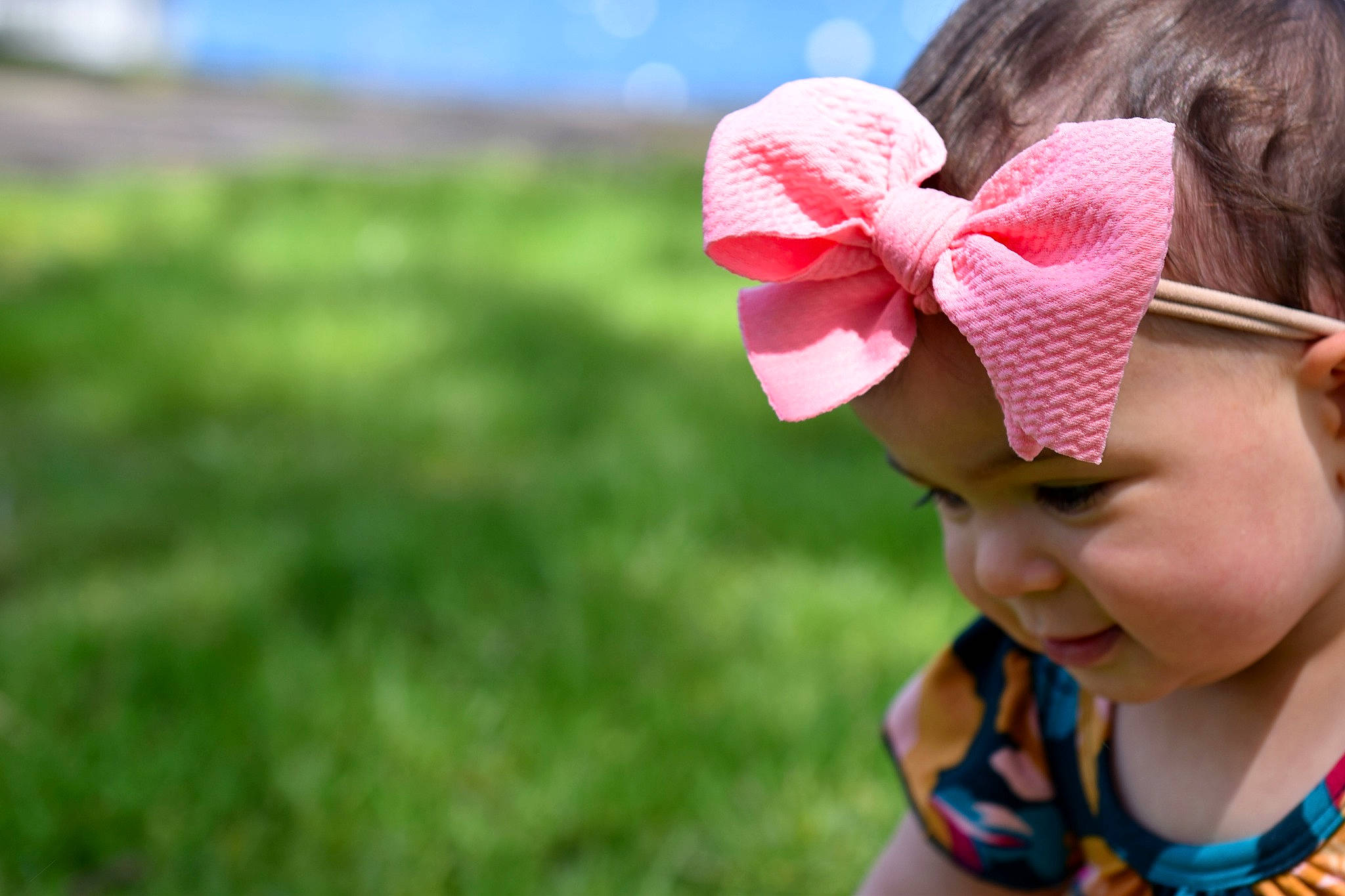 Eviana is registered to the contest to win money with this photo: auto_part, automotive_wheel_system, child, ear, fashion_accessory, fun, grass, hair_accessory, hair_tie, happy, hat, headband, headgear, person, pink, plant, skin, smile, summer, toddler