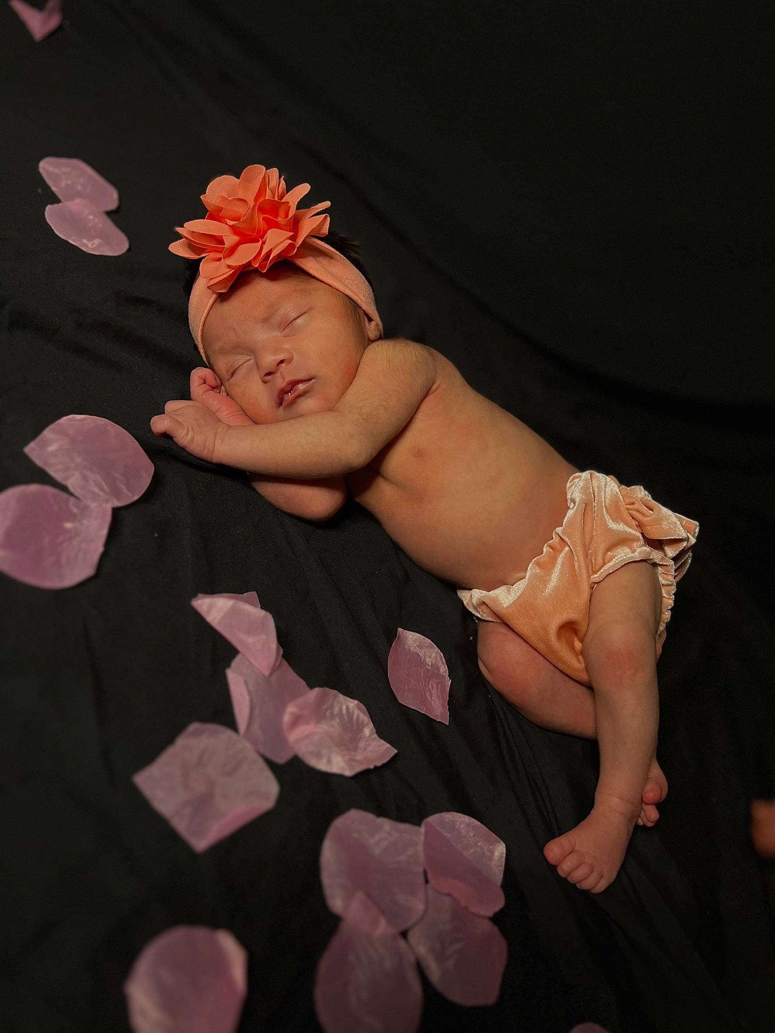 Adalyn is registered to the contest to win money with this photo: baby, baby_toddler_clothing, child, entertainment, event, fashion_accessory, finger, flash_photography, flesh, flooring, hair_accessory, headband, headpiece, headwear, human_leg, nail, peach, person, petal, pink