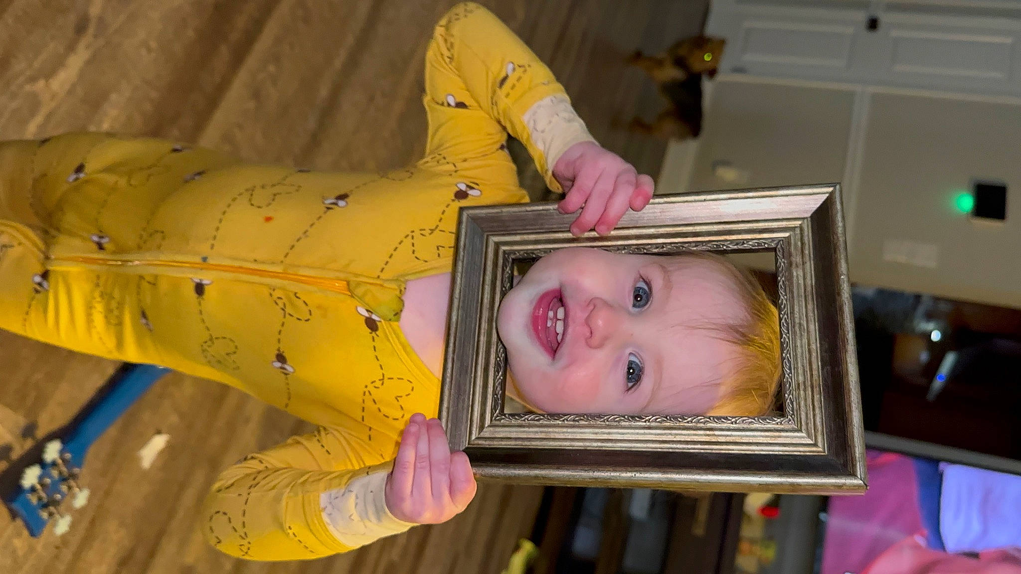 Christian is registered to the contest to win money with this photo: art, baby, baby_products, baby_toddler_clothing, cheek, child, eyelash, fun, happy, joy, magenta, person, pink, room, smile, textile, toddler, visual_arts, wood, yellow