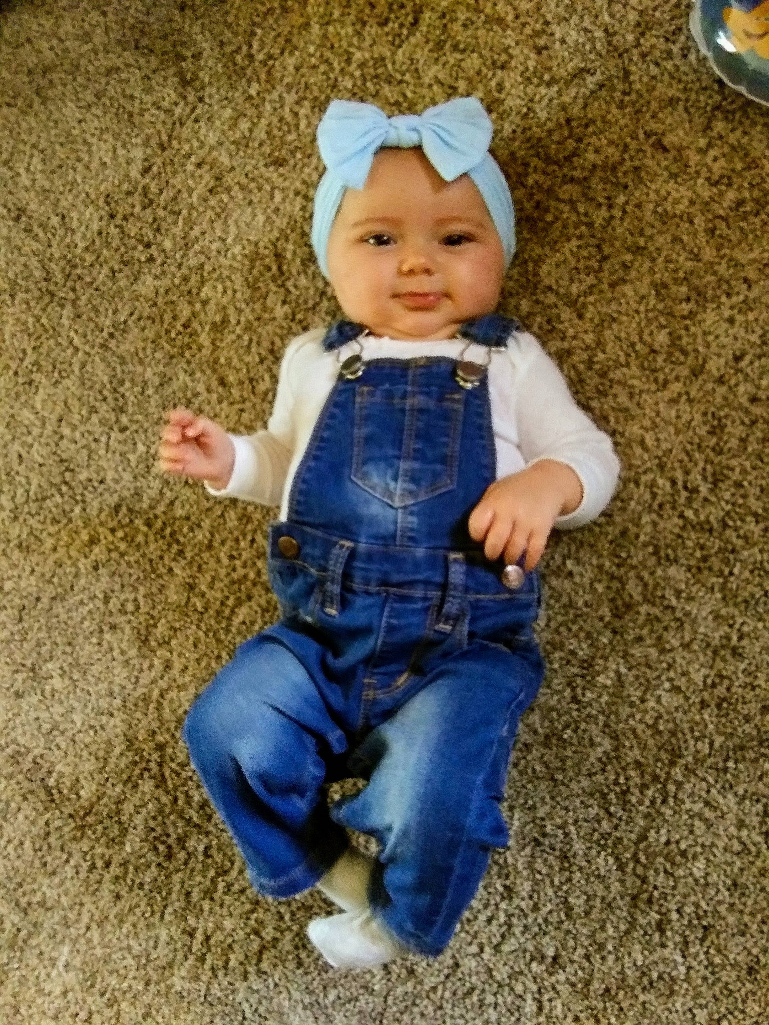 Juniper is registered to the contest to win money with this photo: baby, blue, cheek, child, denim, headgear, headwear, jeans, overall, person, play, sitting, smile, toddler