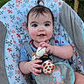 baby, child, infant, swing, toy, plush_toy, giraffe, outdoor, garden, flower, greenery, happy, smiling, blue_shirt, seat, straps, cute, portrait, person, young_child
