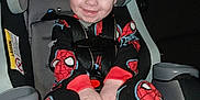 Landyn Scott joined the competition — help win amazing prizes! baby, blue_eyes, car_interior, car_seat, child, clothing, cozy, cute, footwear, happy, indoor, infant, pajamas, person, seatbelt, sitting, smiling, spiderman, toddler, young_child